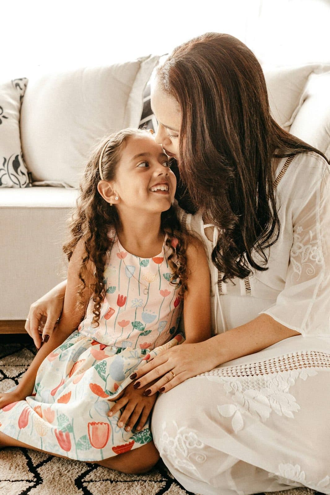 Mother and daughter sitting together on the floor